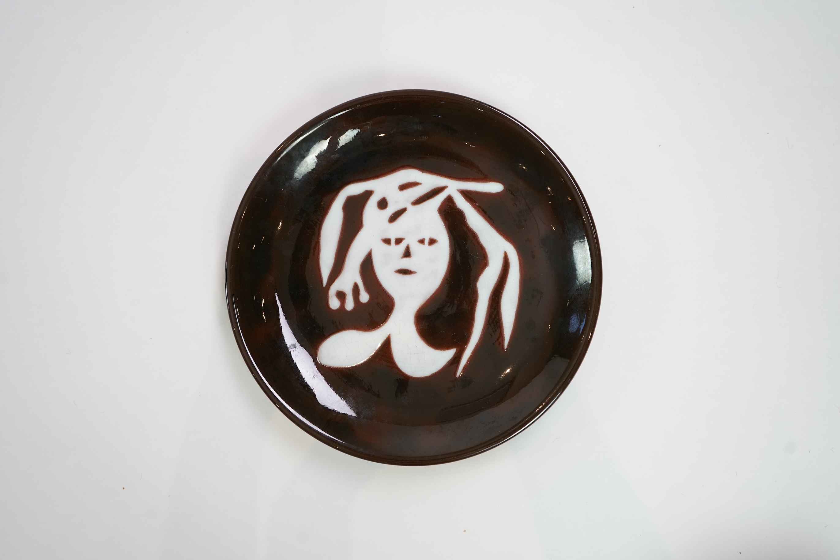 Jean Lurçat (1892-1966): A brown glazed earthenware plate, decorated with a stylised central figure